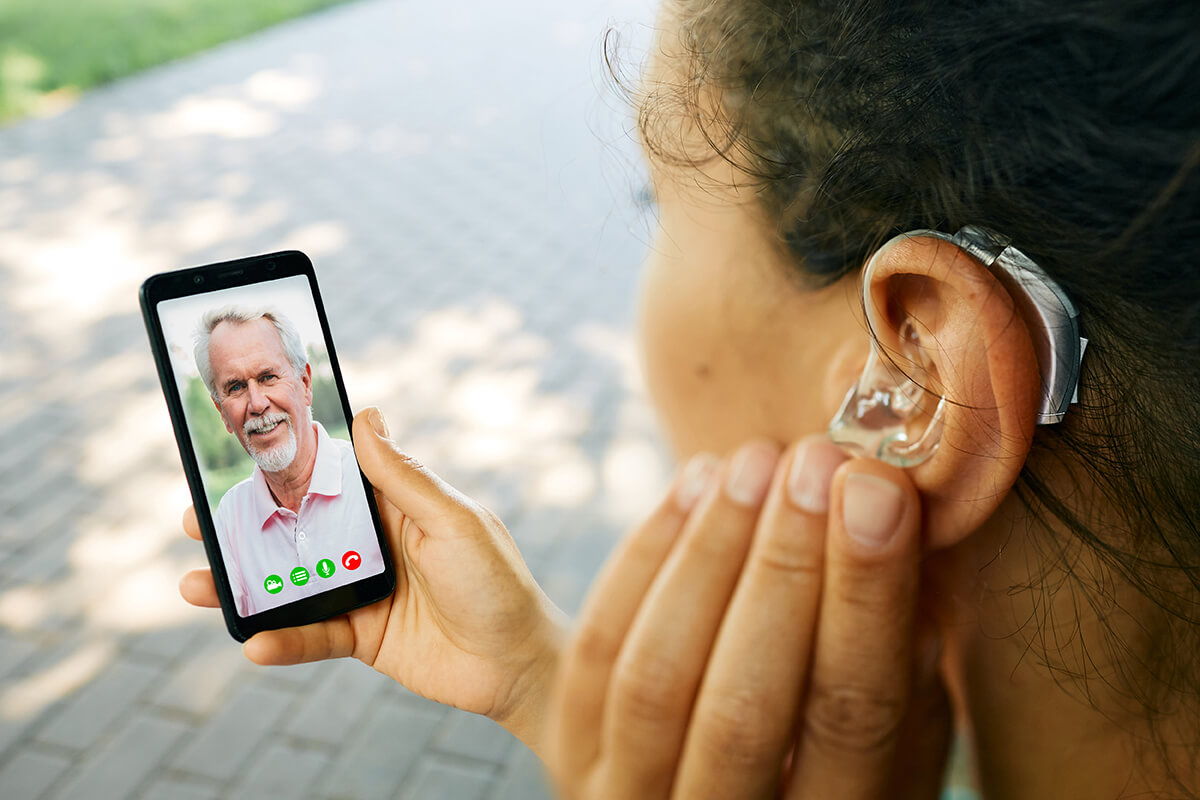 Deaf Woman on phone with Hearing Aid