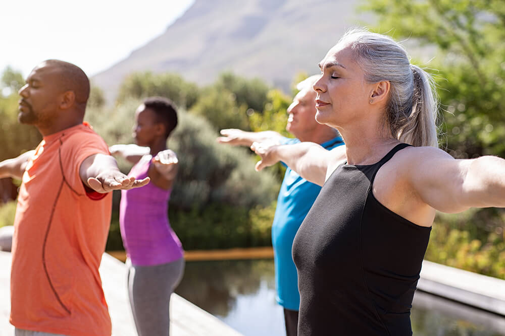 People practicing yoga outside