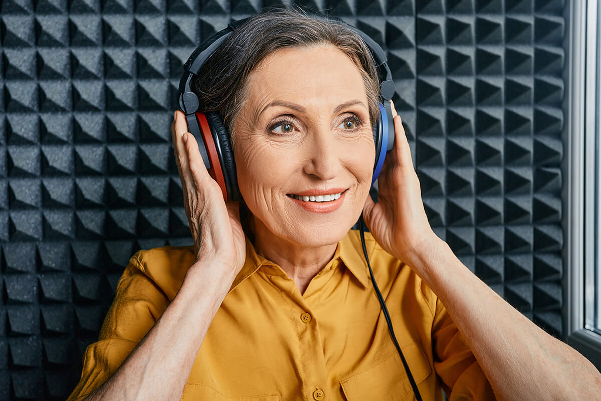 Elderly woman in a hearing booth