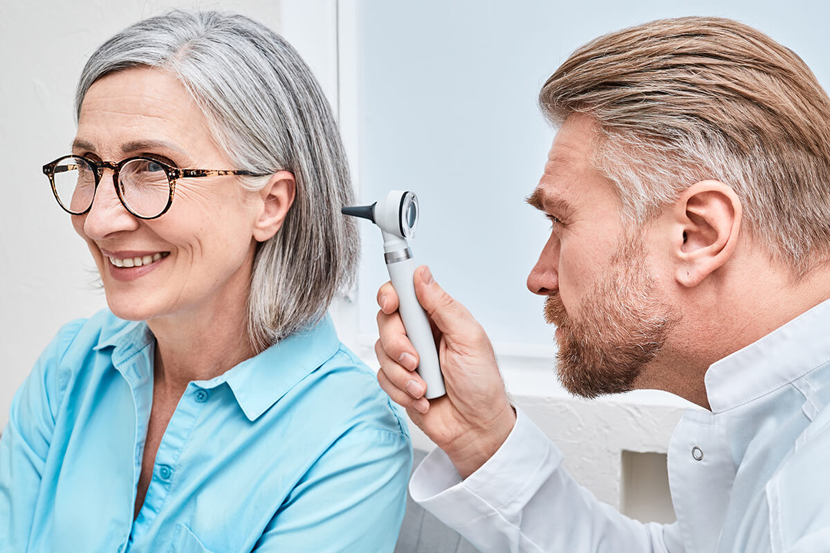 Otolaryngologist checking patient ear