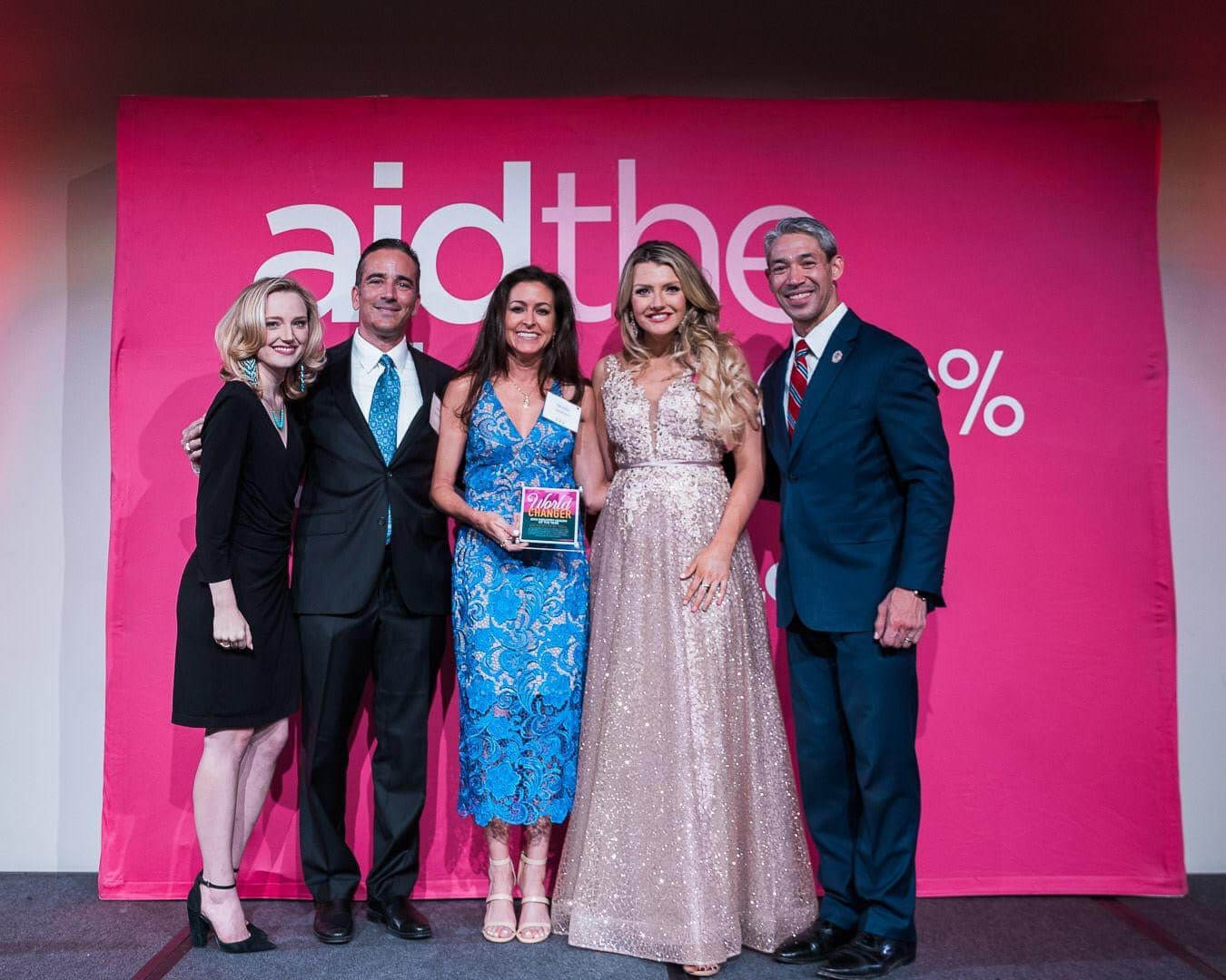 Doctors and Audiologists in front of pink backdrop