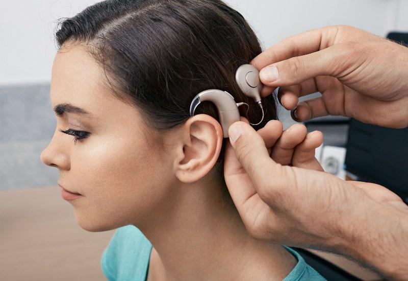A patient receives a cochlear implant hearing aid system. 